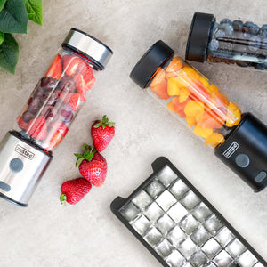 Three Zestee blenders filled with fruit and a filled ice tray overhead view